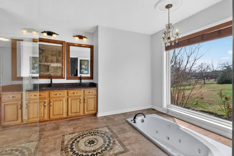a view of a bathroom with a tub shower and mirror