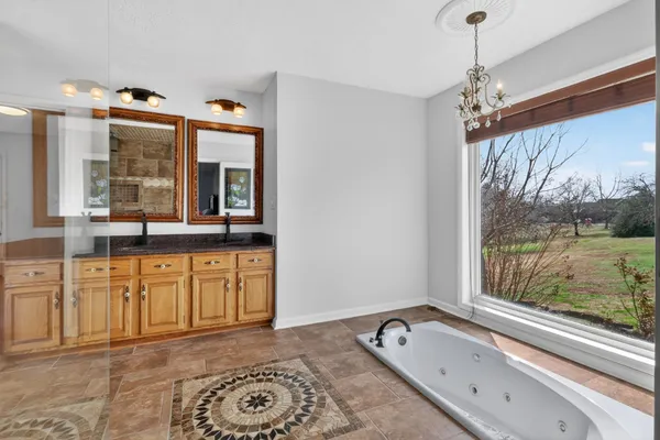 a kitchen with granite countertop kitchen island stainless steel appliances a table and chairs