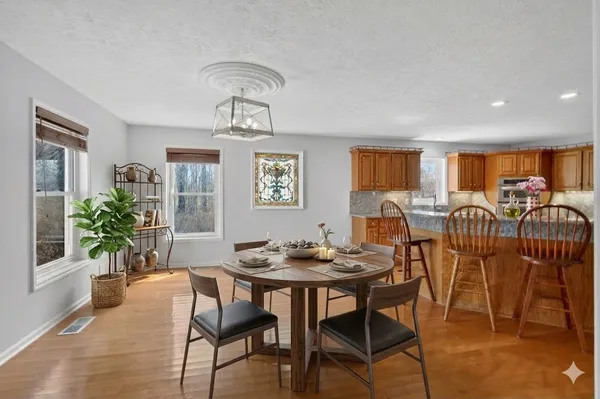 a view of a livingroom with furniture wooden floor and windows