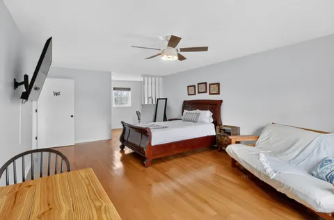 a living room with furniture ceiling fan and a rug