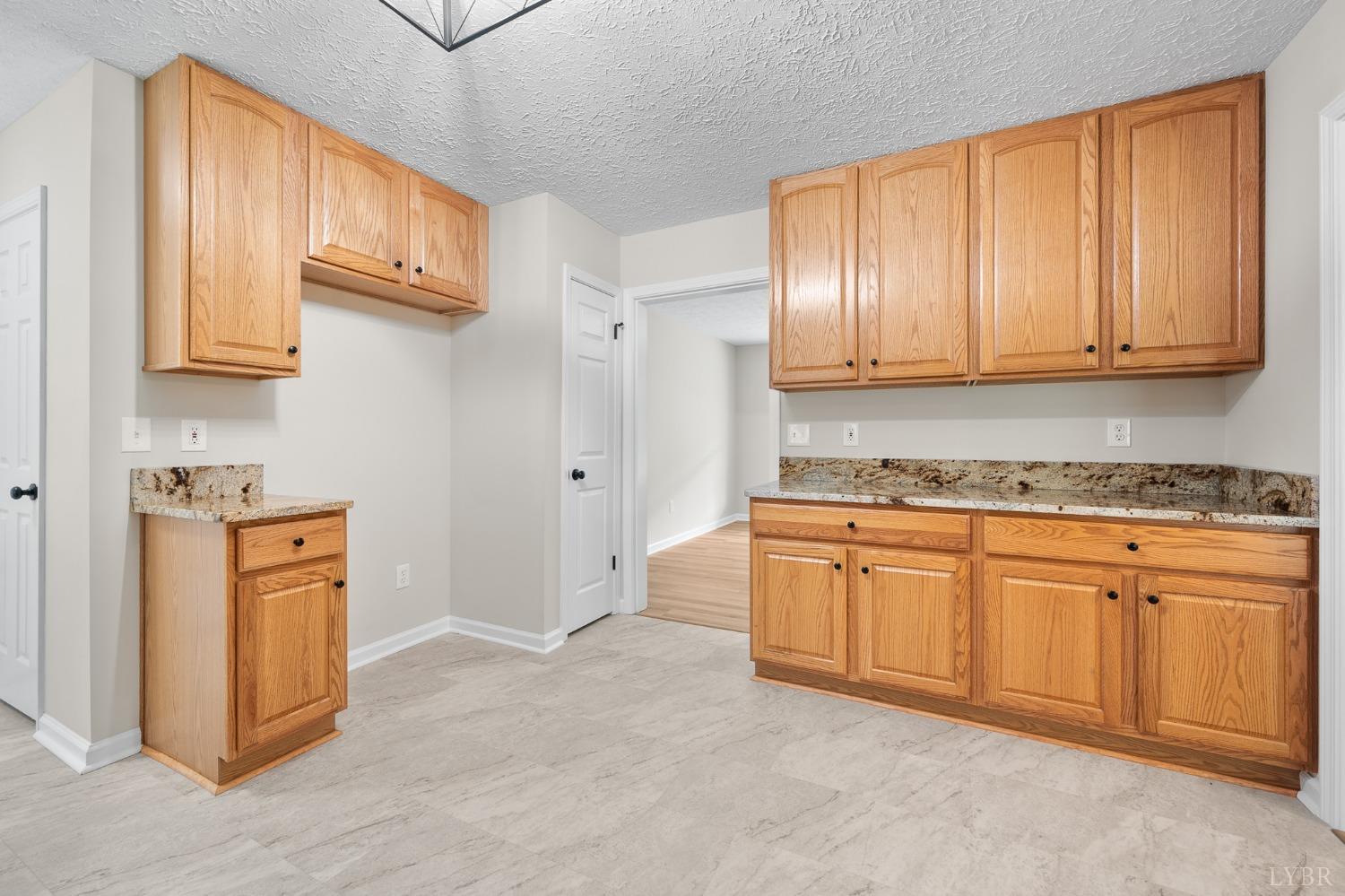 617 North Fork Road Amherst, VA 24521 - Photo 18 of 62 a kitchen with granite countertop cabinets and refrigerator