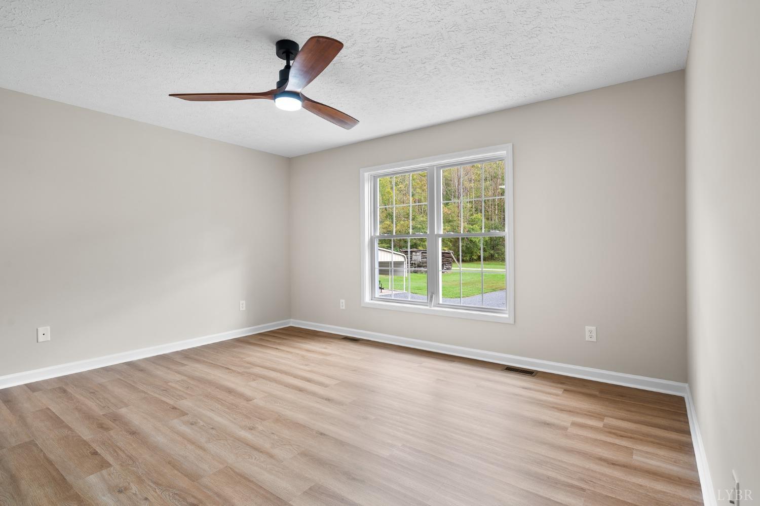 617 North Fork Road Amherst, VA 24521 - Photo 30 of 62 a view of an empty room with wooden floor and a window