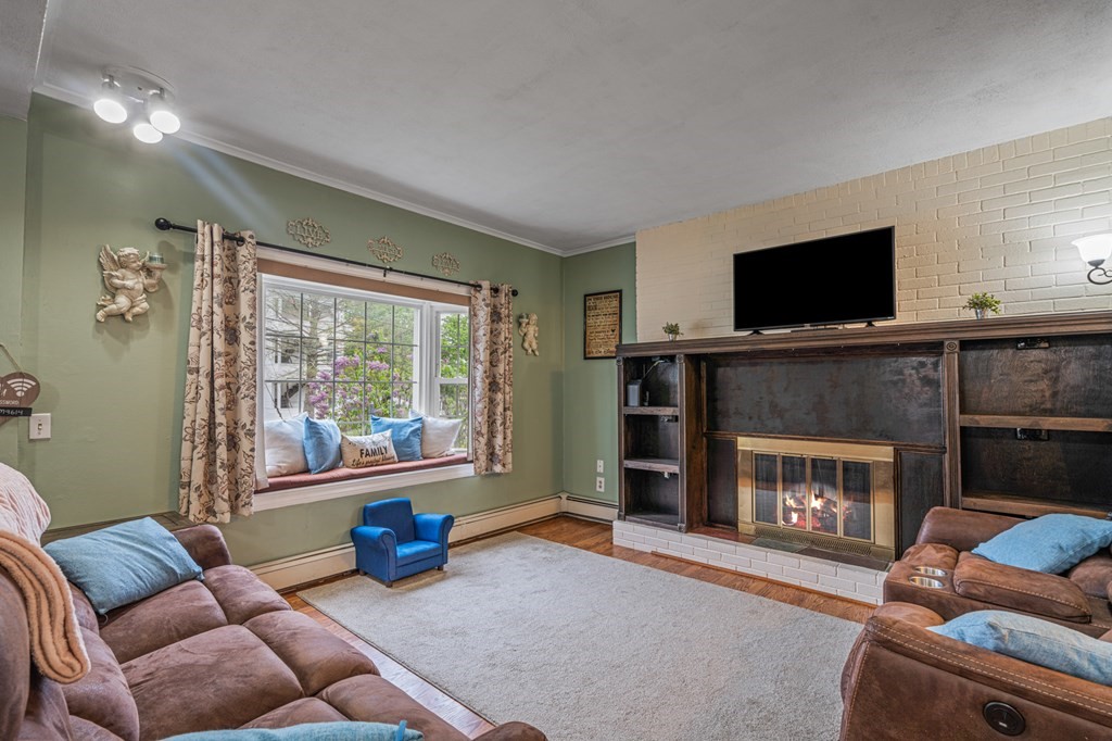 569 Gaskill Street Woonsocket, RI 02895 - Photo 11 of 33 a living room with furniture or flat screen tv and a fireplace