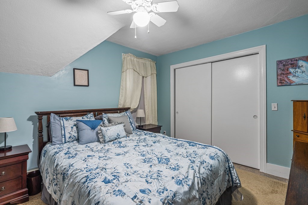 569 Gaskill Street Woonsocket, RI 02895 - Photo 15 of 33 a bedroom with a large bed and a chandelier