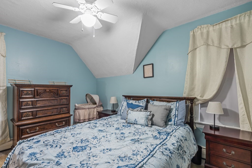569 Gaskill Street Woonsocket, RI 02895 - Photo 16 of 33 a bedroom with a bed and a chandelier