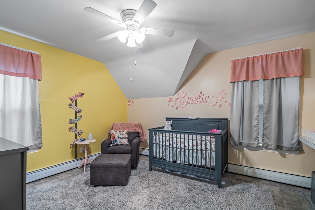569 Gaskill Street Woonsocket, RI 02895 - Photo 18 of 33 a bedroom with a bed and a chandelier