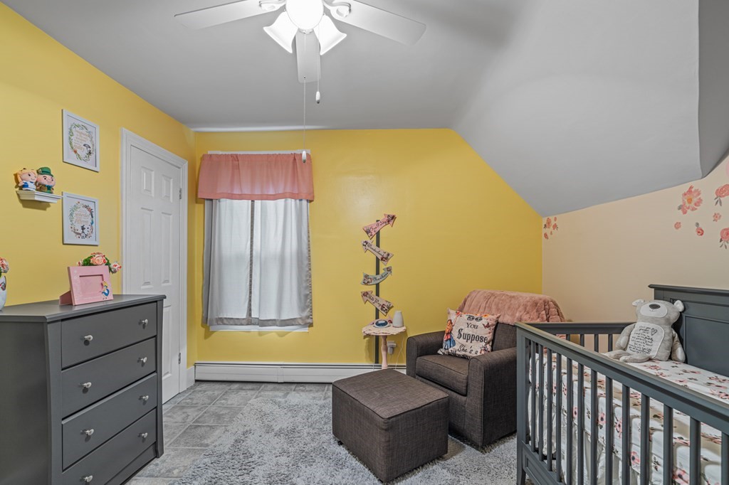 569 Gaskill Street Woonsocket, RI 02895 - Photo 19 of 33 a bedroom with a bed and a dresser