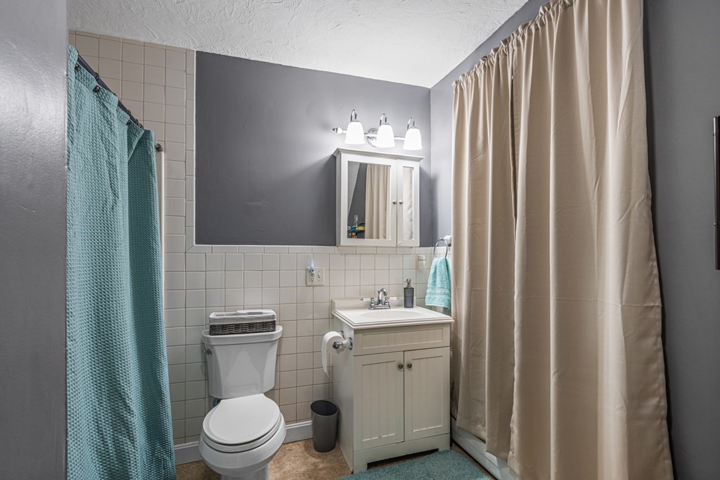 569 Gaskill Street Woonsocket, RI 02895 - Photo 24 of 33 a bathroom with a toilet a sink and mirror