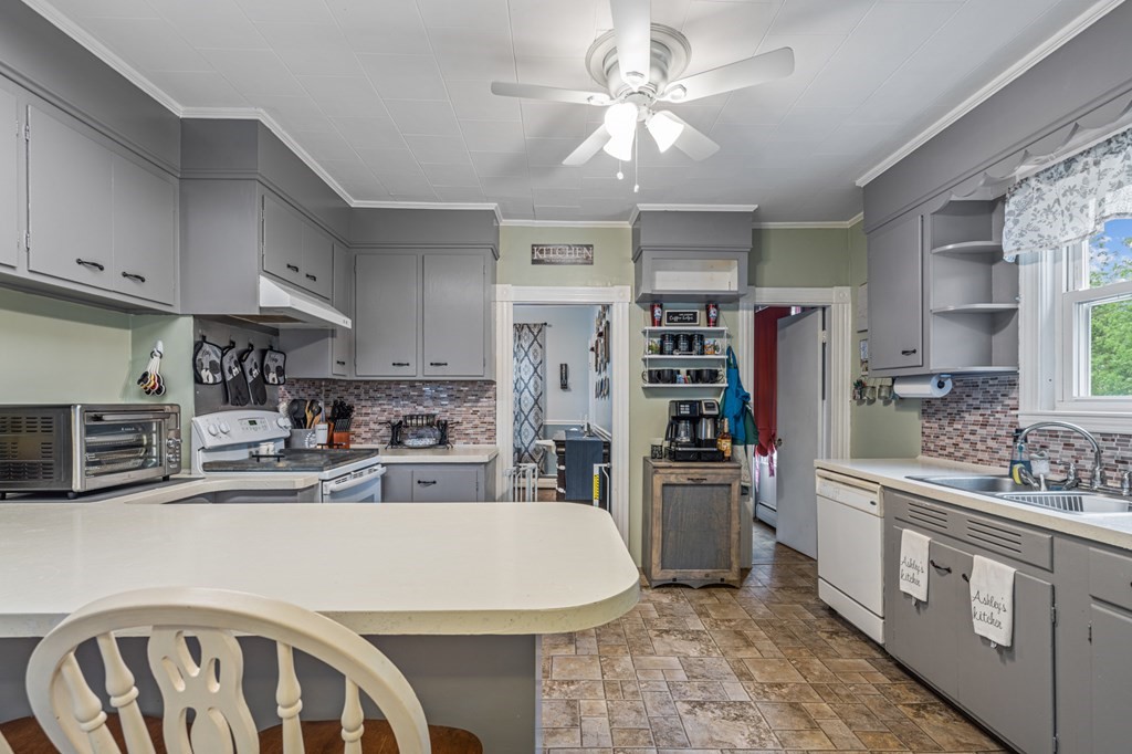 569 Gaskill Street Woonsocket, RI 02895 - Photo 4 of 33 a kitchen with stainless steel appliances granite countertop a refrigerator a stove a sink dishwasher and white cabinets with wooden floor