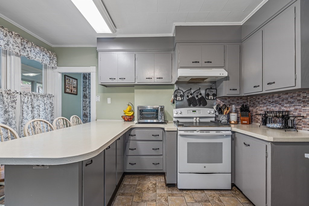 569 Gaskill Street Woonsocket, RI 02895 - Photo 6 of 33 a kitchen with a sink stove and cabinets