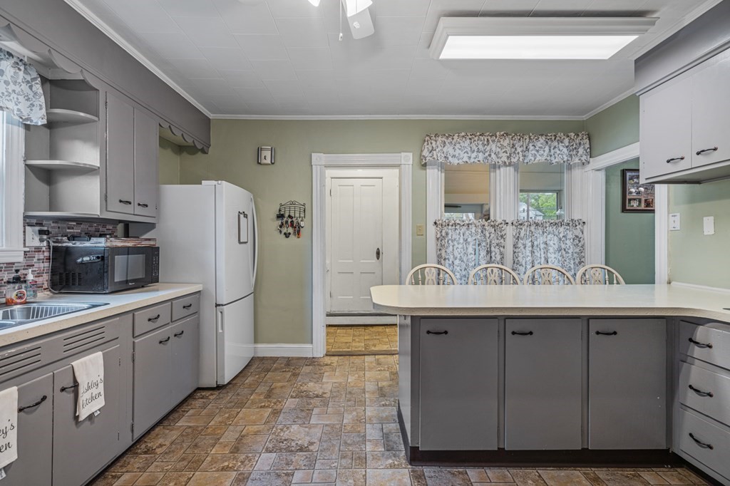569 Gaskill Street Woonsocket, RI 02895 - Photo 7 of 33 a kitchen with a sink and refrigerator