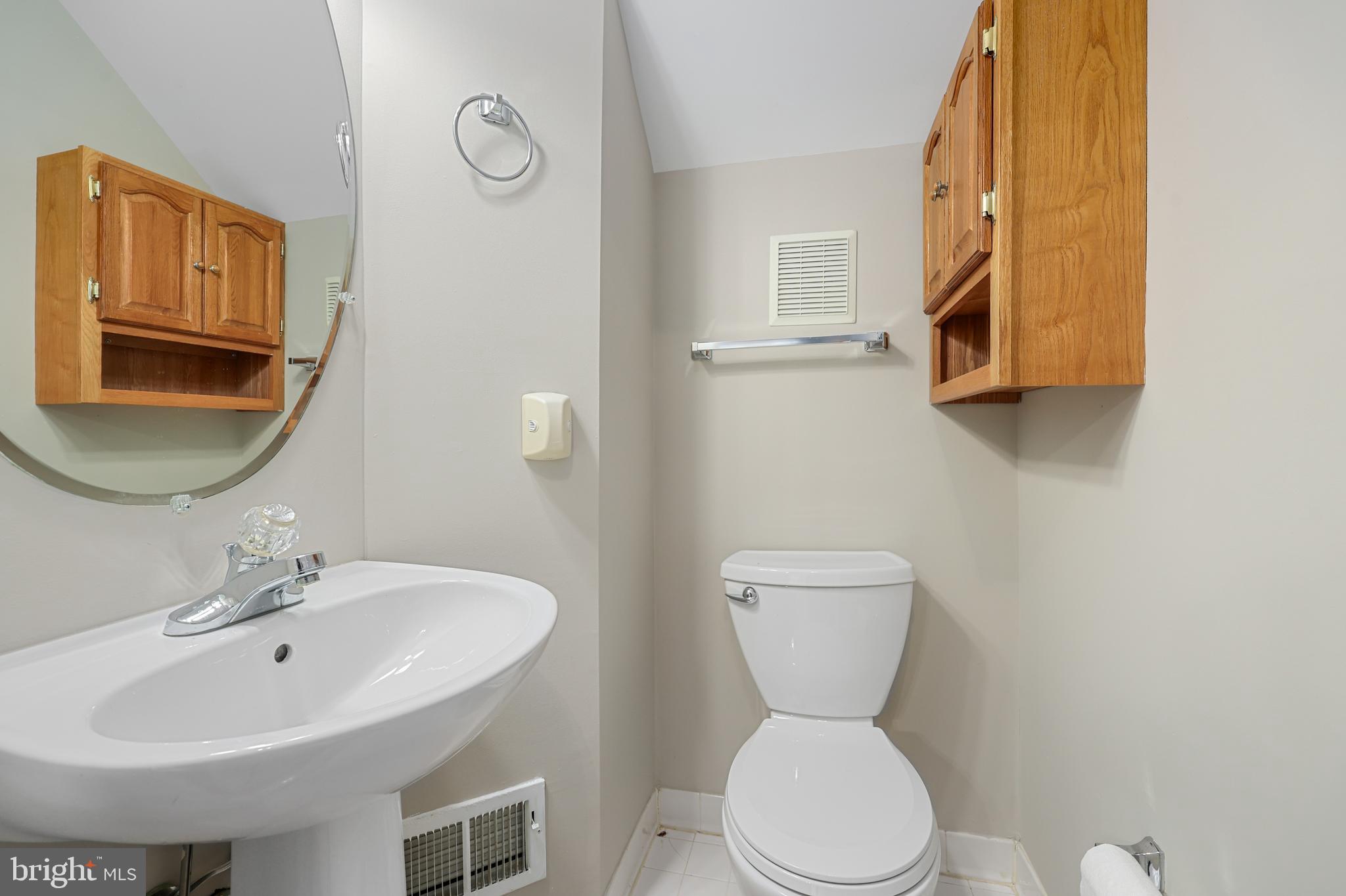 11824 Breton Court, Unit 24A Reston, VA 20191 - Photo 12 of 34 a bathroom with a toilet sink and mirror