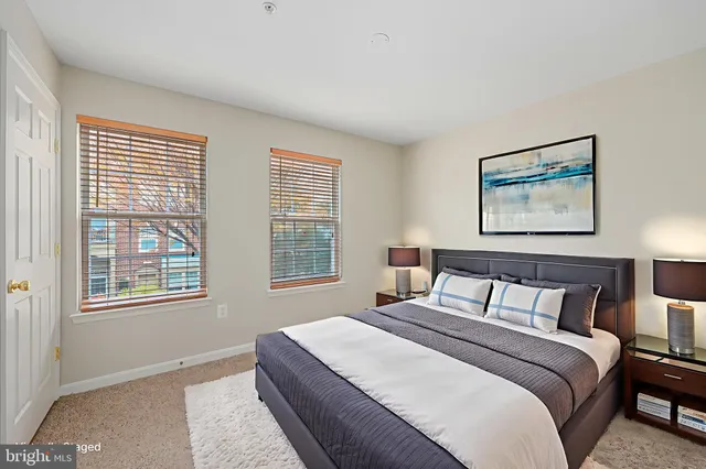 a bedroom with a large bed and a window