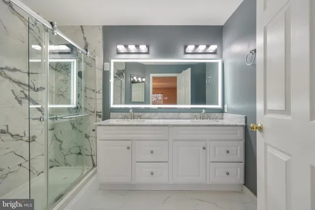 a bathroom with a sink vanity and a mirror