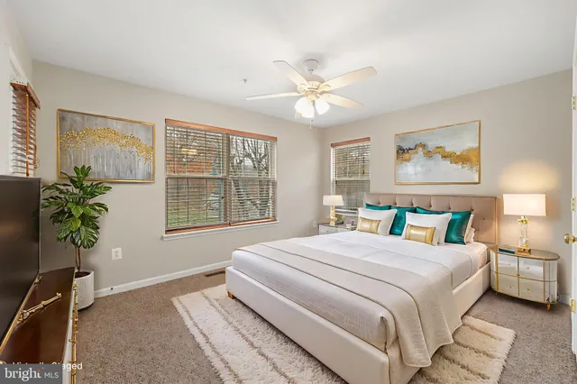 a bedroom with a bed and a potted plant
