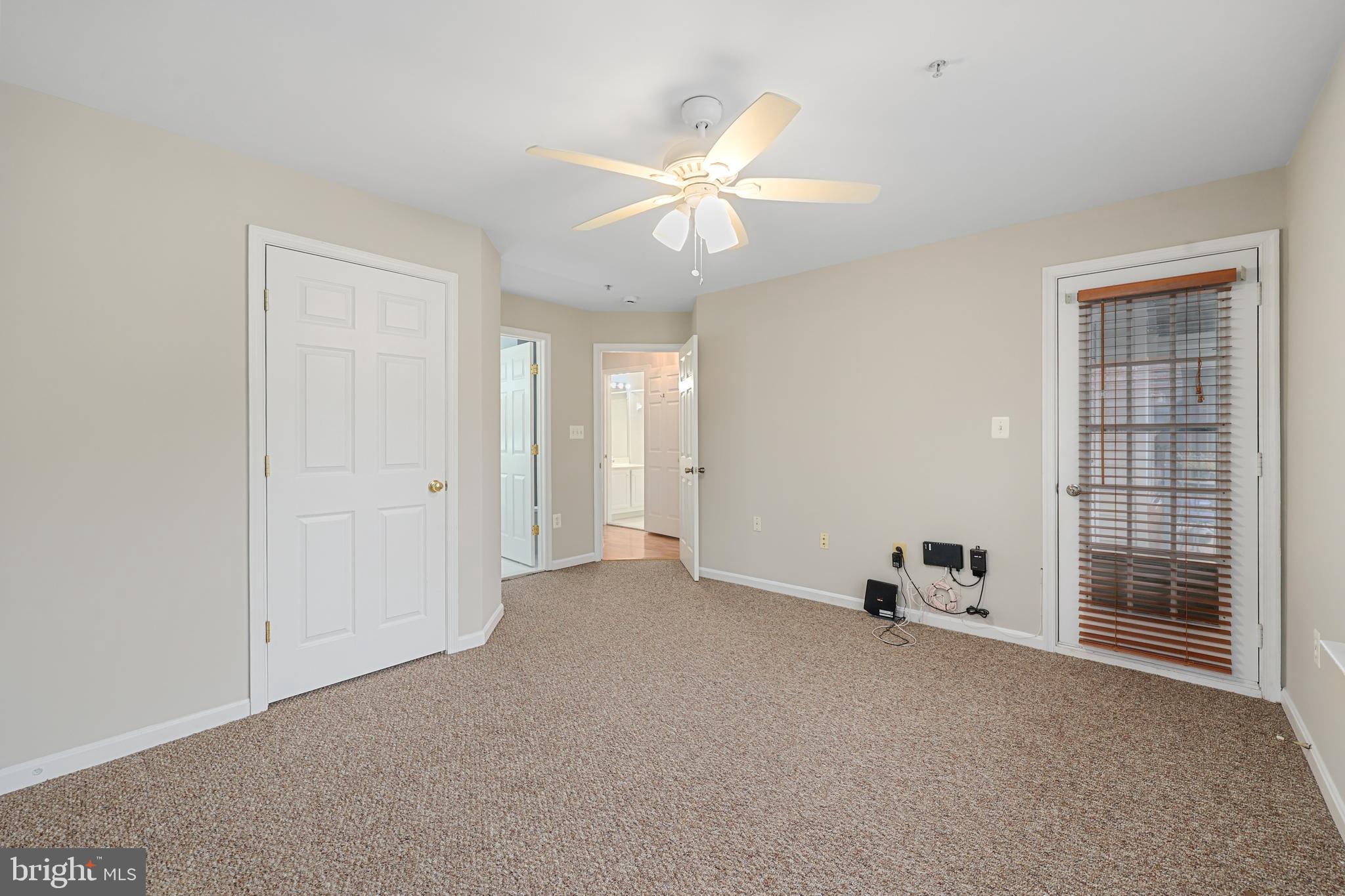 11824 Breton Court, Unit 24A Reston, VA 20191 - Photo 29 of 34 a view of a livingroom with a ceiling fan and window