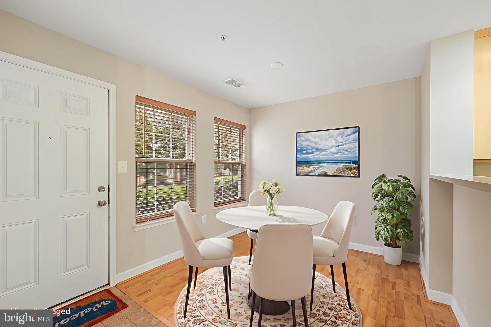 11824 Breton Court, Unit 24A Reston, VA 20191 - Photo 7 of 34 a view of a dining room with furniture window and wooden floor