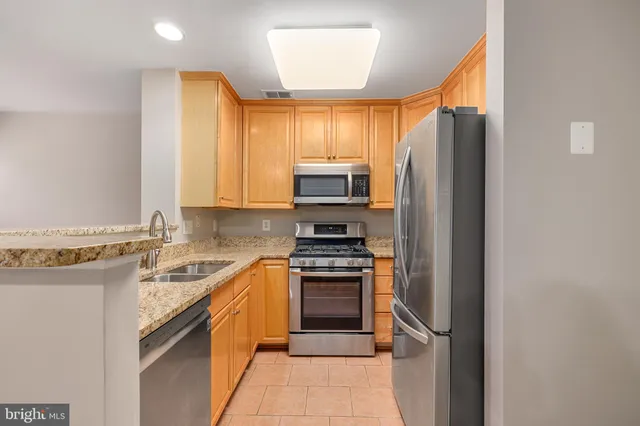 a kitchen with a sink stove and refrigerator
