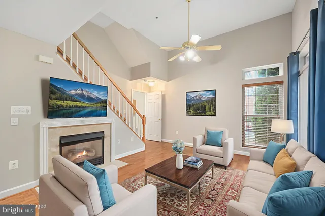 a living room with furniture a flat screen tv and a fireplace