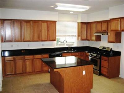 667 Sierra Avenue Reedley, CA 93654 - Photo 3 of 12 Granite Counter Tops and Stainless Steel Appliances in Kitchen