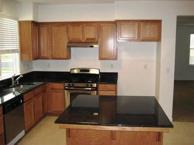 667 Sierra Avenue Reedley, CA 93654 - Photo 4 of 12 Granite Counter Tops and Stainless Steel Appliances in Kitchen