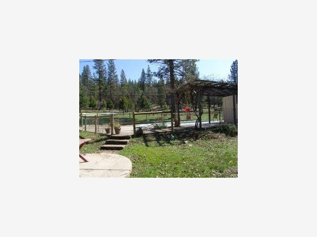 5677 Swiss Ranch Road Mountain Ranch, CA 95246 - Photo 8 of 9 a picture of a bench in a backyard