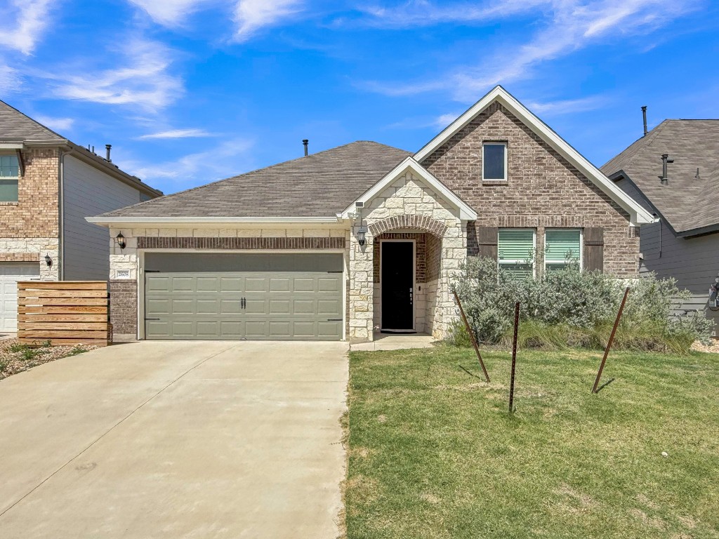 2608 Emerson Trail Leander, TX 78641 - Photo 1 of 1 a front view of a house with a yard and garage