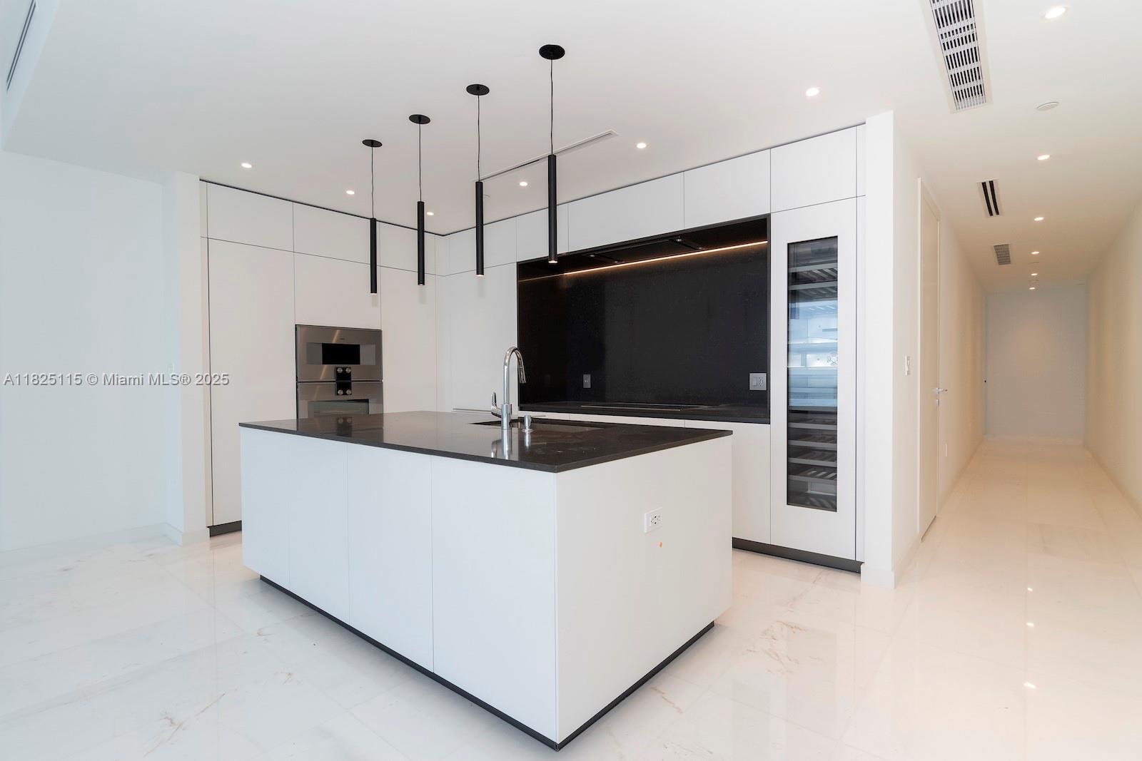 300 Biscayne Blvd Way, Unit 3902 Miami, FL 33131 - Photo 11 of 41 a kitchen with stainless steel appliances a stove a microwave and a refrigerator