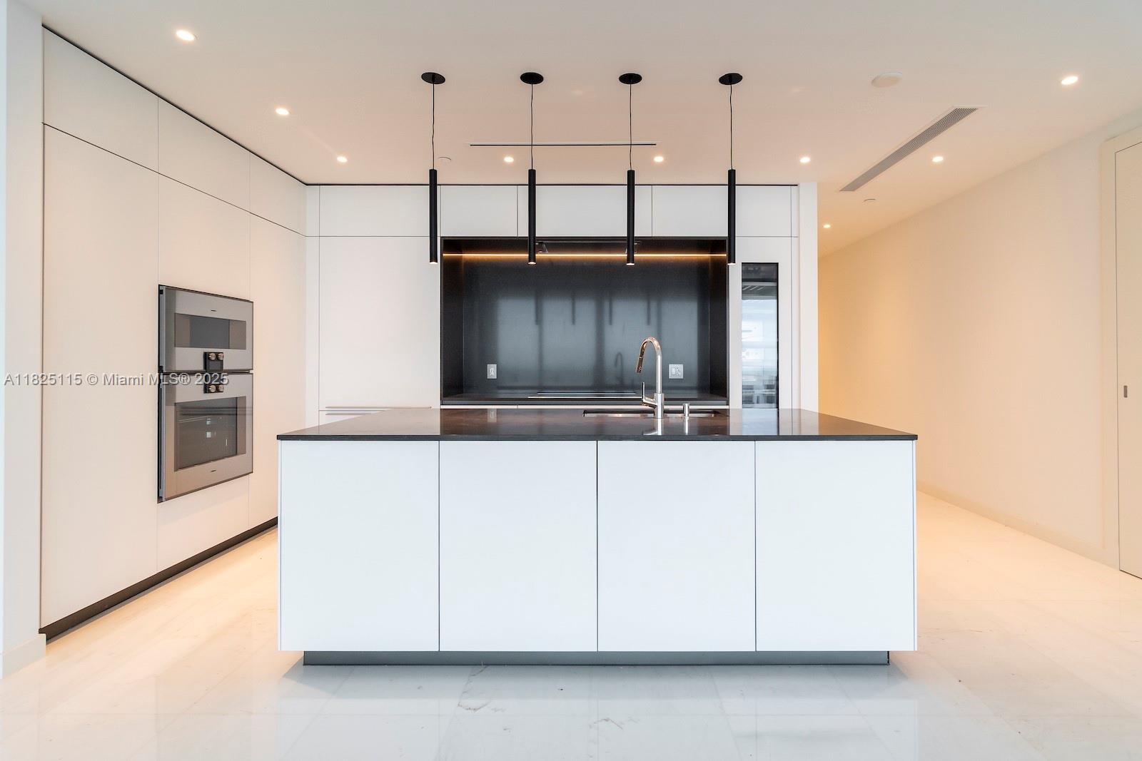 300 Biscayne Blvd Way, Unit 3902 Miami, FL 33131 - Photo 13 of 41 a kitchen with kitchen island a refrigerator and a stove