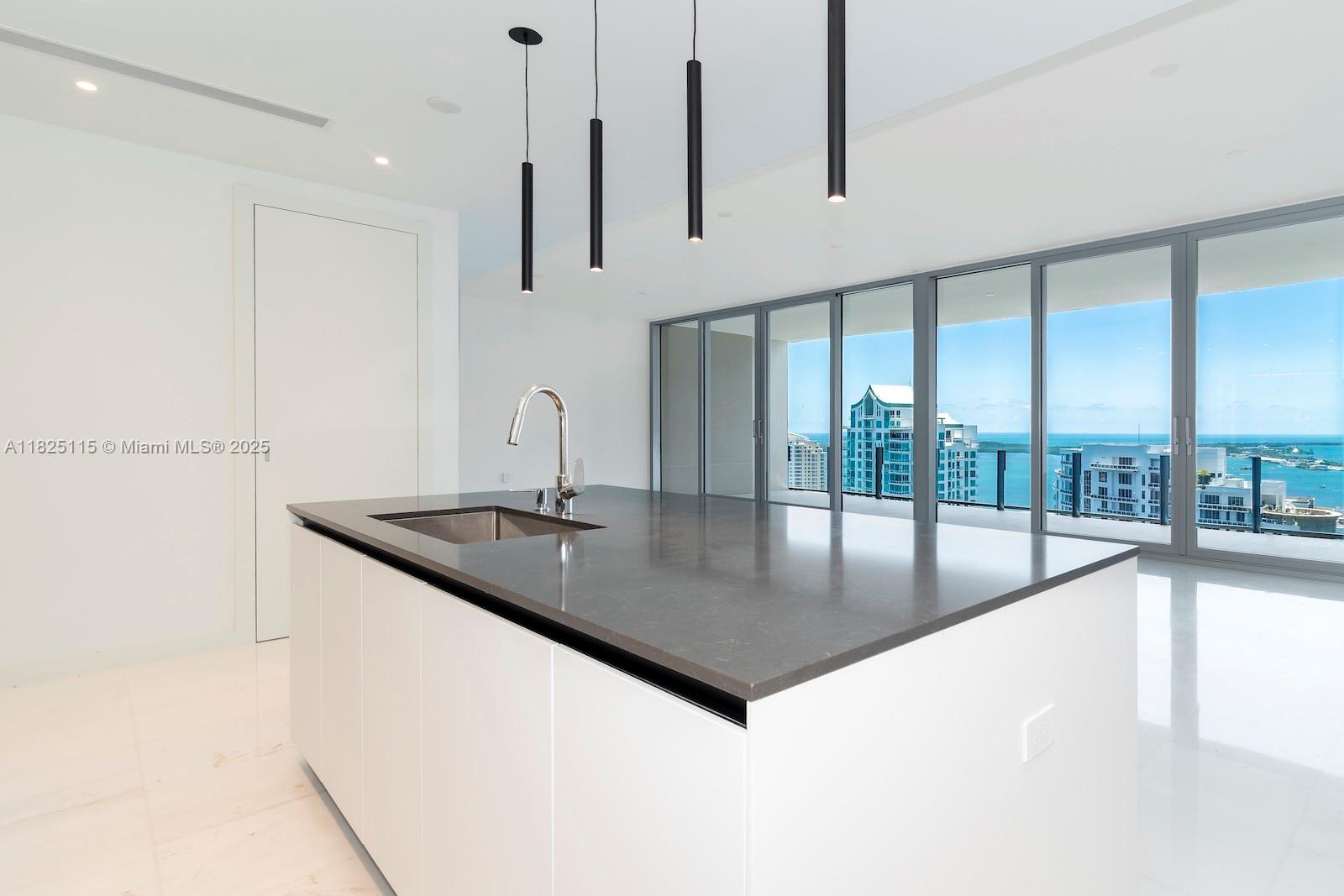 300 Biscayne Blvd Way, Unit 3902 Miami, FL 33131 - Photo 18 of 41 a kitchen with stainless steel appliances granite countertop a sink a oven and a large window with the outer view