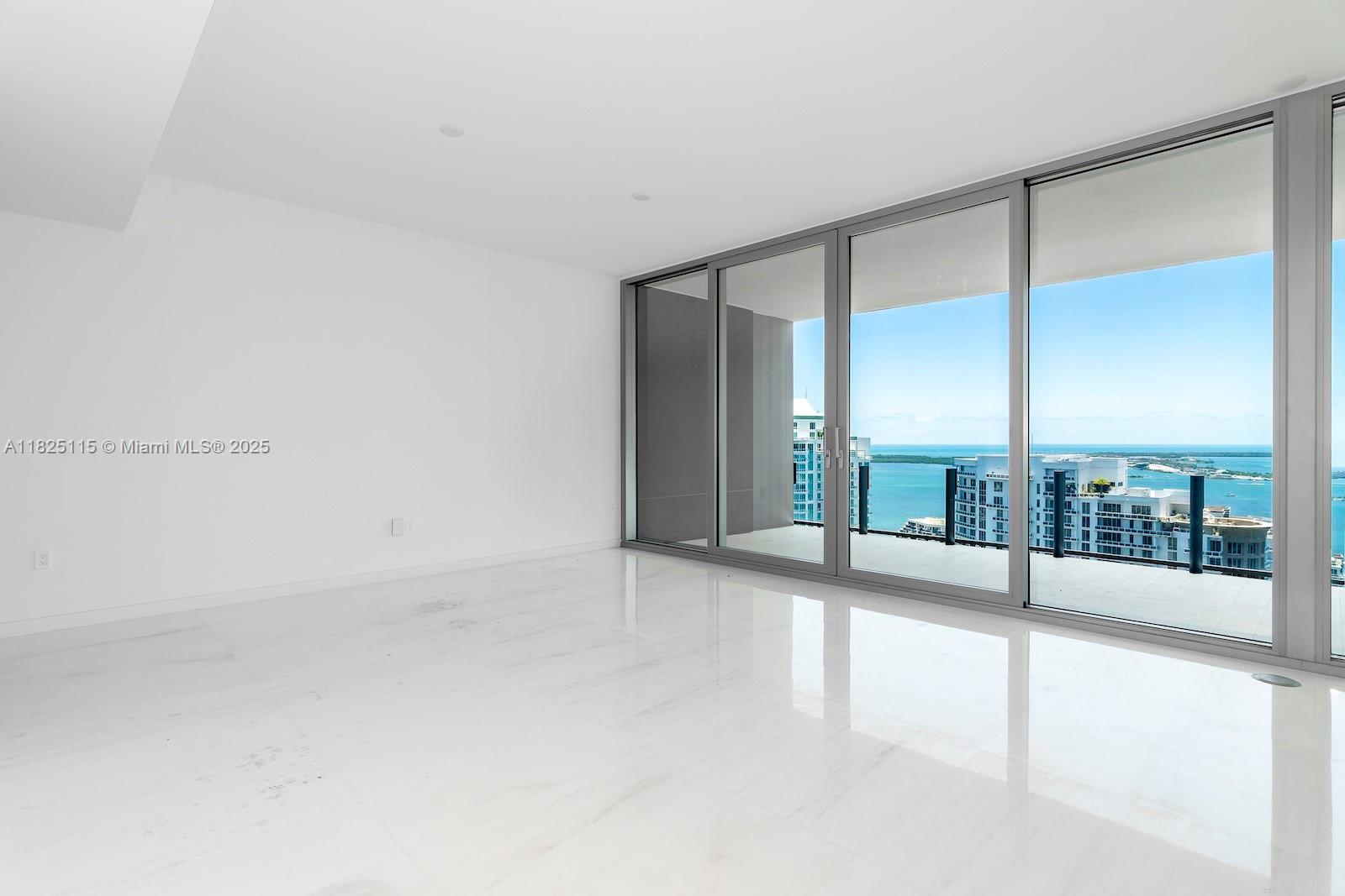 300 Biscayne Blvd Way, Unit 3902 Miami, FL 33131 - Photo 20 of 41 an empty room with sliding glass door and mountain view