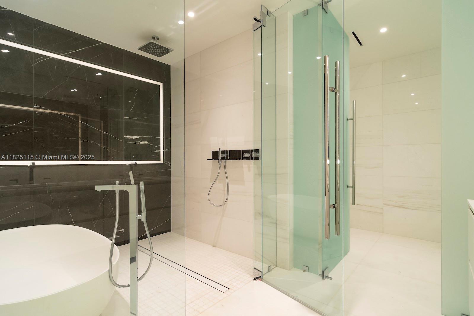 300 Biscayne Blvd Way, Unit 3902 Miami, FL 33131 - Photo 32 of 41 a bathroom with a glass shower door