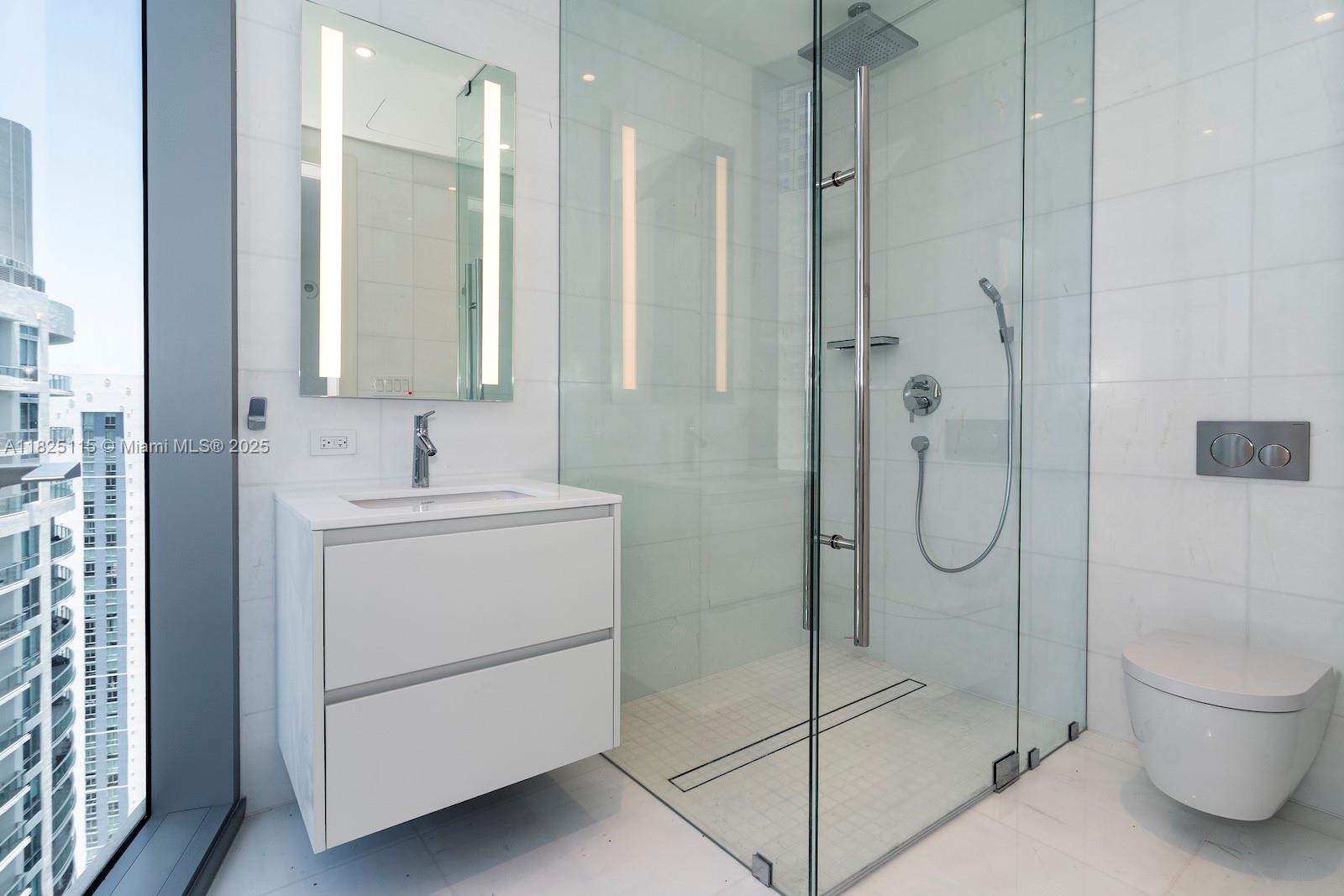 300 Biscayne Blvd Way, Unit 3902 Miami, FL 33131 - Photo 37 of 41 a bathroom with a shower sink and mirror