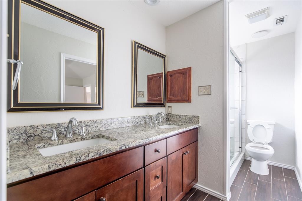 809 Simon Drive Plano, TX 75025 - Photo 11 of 24 a bathroom with a granite countertop sink and a mirror