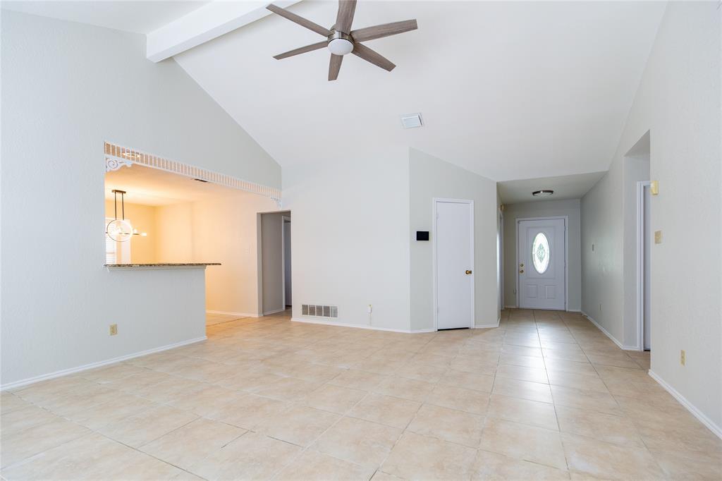 809 Simon Drive Plano, TX 75025 - Photo 14 of 24 a view of a livingroom with an empty space and a window
