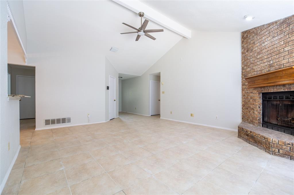 809 Simon Drive Plano, TX 75025 - Photo 15 of 24 an empty room with fan and fireplace
