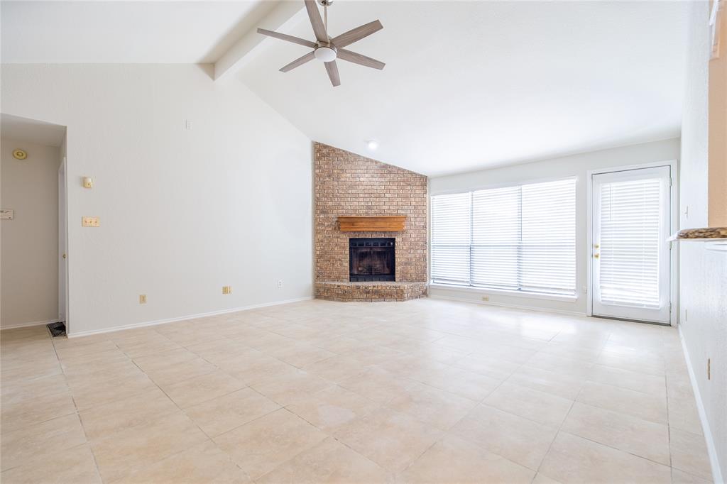 809 Simon Drive Plano, TX 75025 - Photo 16 of 24 an empty room with fireplace and fan