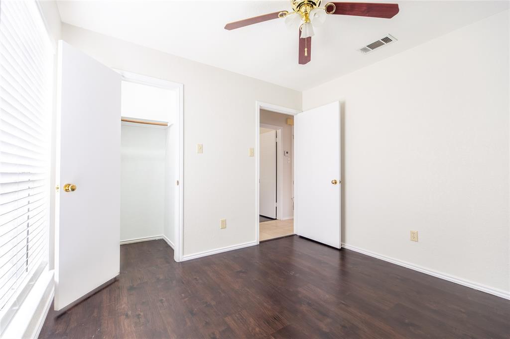 809 Simon Drive Plano, TX 75025 - Photo 4 of 24 an empty room with wooden floor and windows