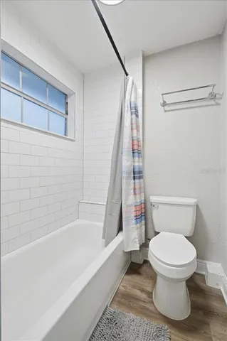 a bathroom with a toilet and shower