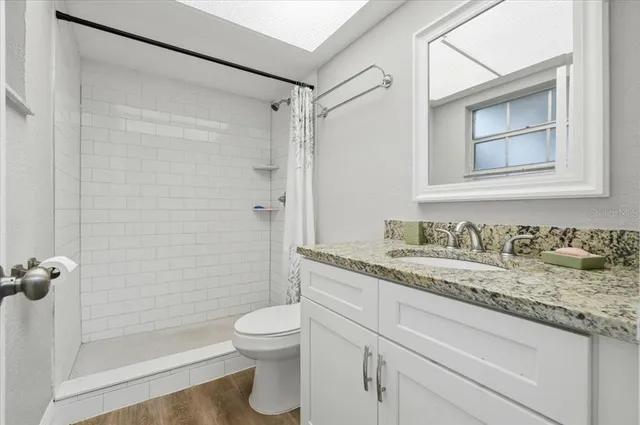 a bedroom with a bed and a large window with outer view