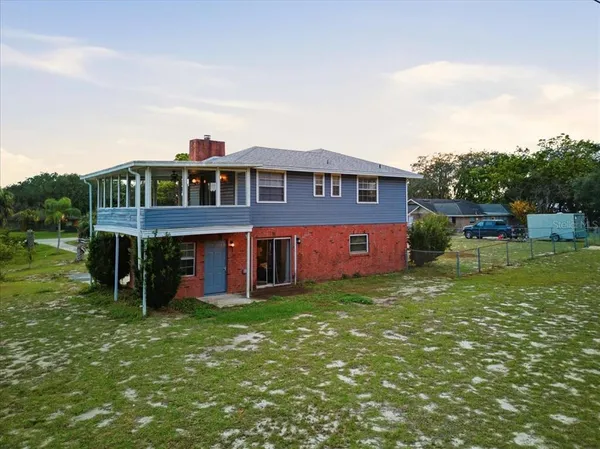 an aerial view of a house with a yard table and chairs