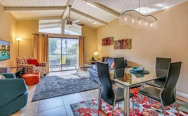 a living room with furniture and a chandelier