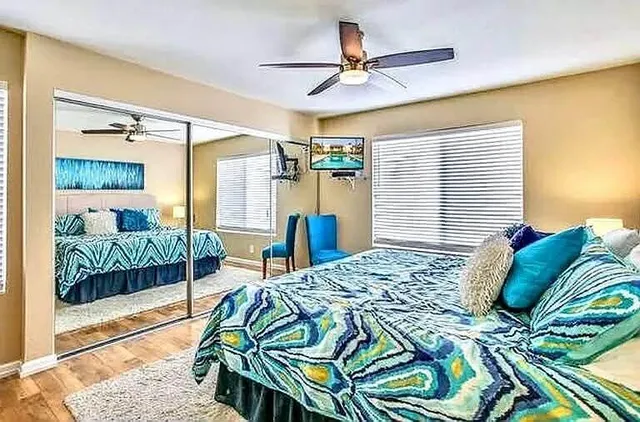 a bedroom with a bed a window and a walk in closet