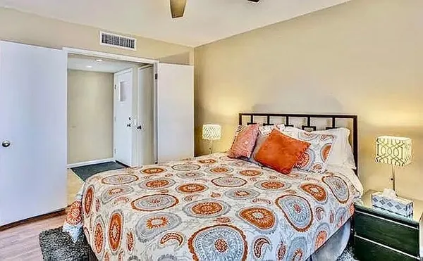 a bedroom with a bed and lamp