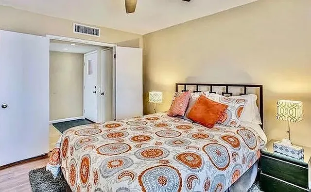 a bedroom with a bed and lamp