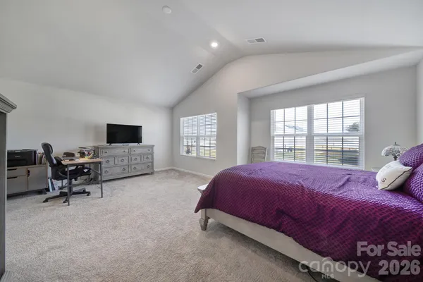a bedroom with a bed and a desk