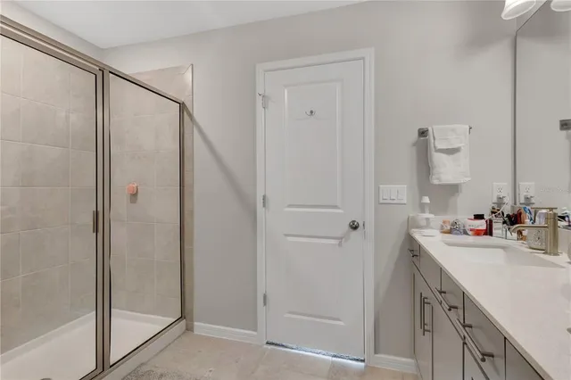 a bathroom with a double vanity sink mirror and shower