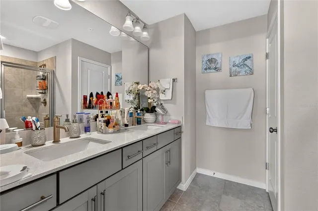 a bathroom with a sink double vanity granite and a mirror