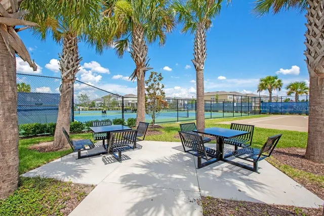 a view of a swimming pool with a lawn chairs under an umbrella