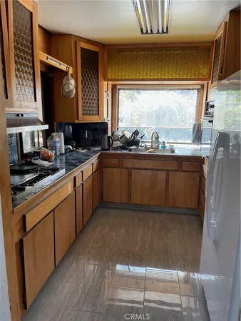 a kitchen with stainless steel appliances granite countertop a sink stove and cabinets